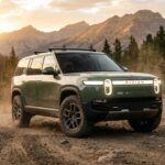 2026 Rivian R2 electric SUV in Launch Green parked on a mountain trail